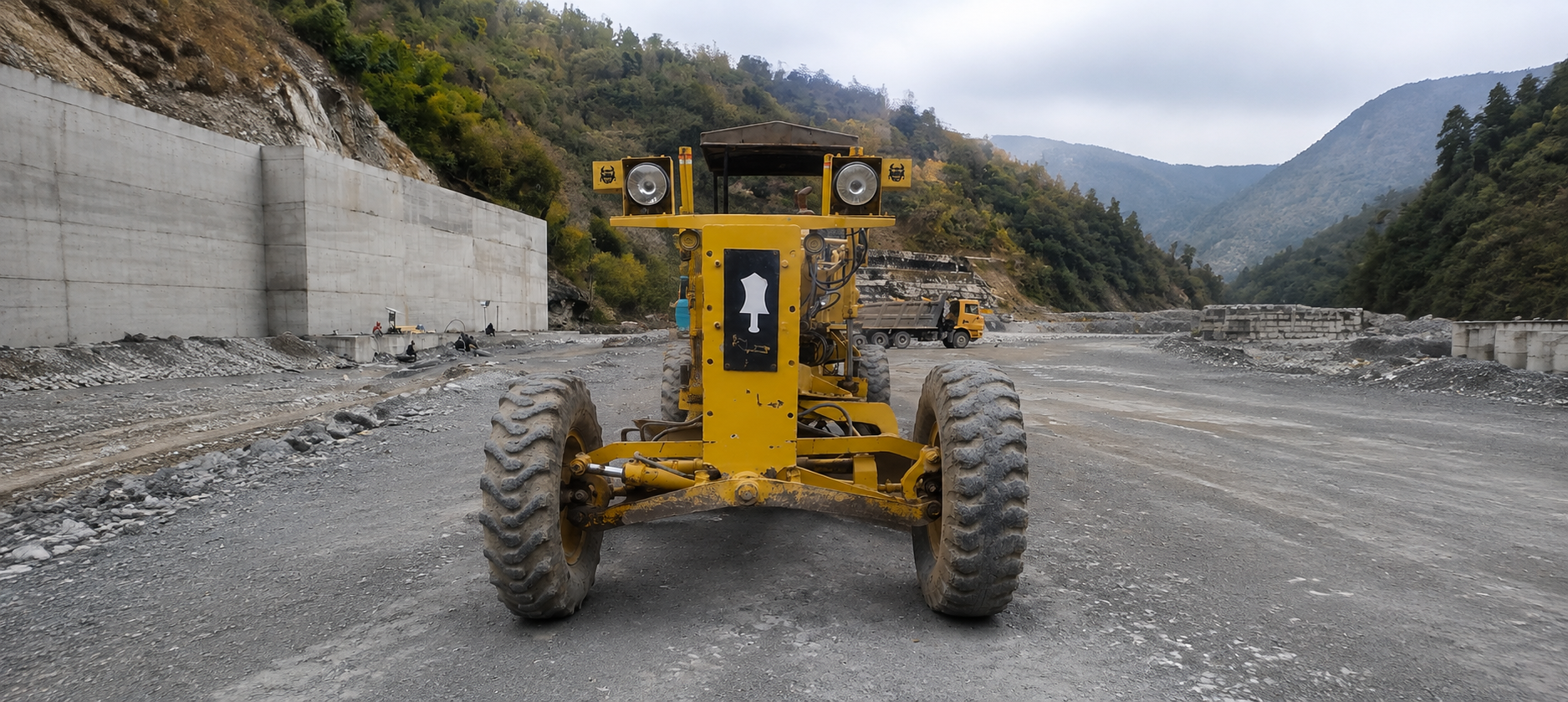 Motor grader levelling ground on a road construction site