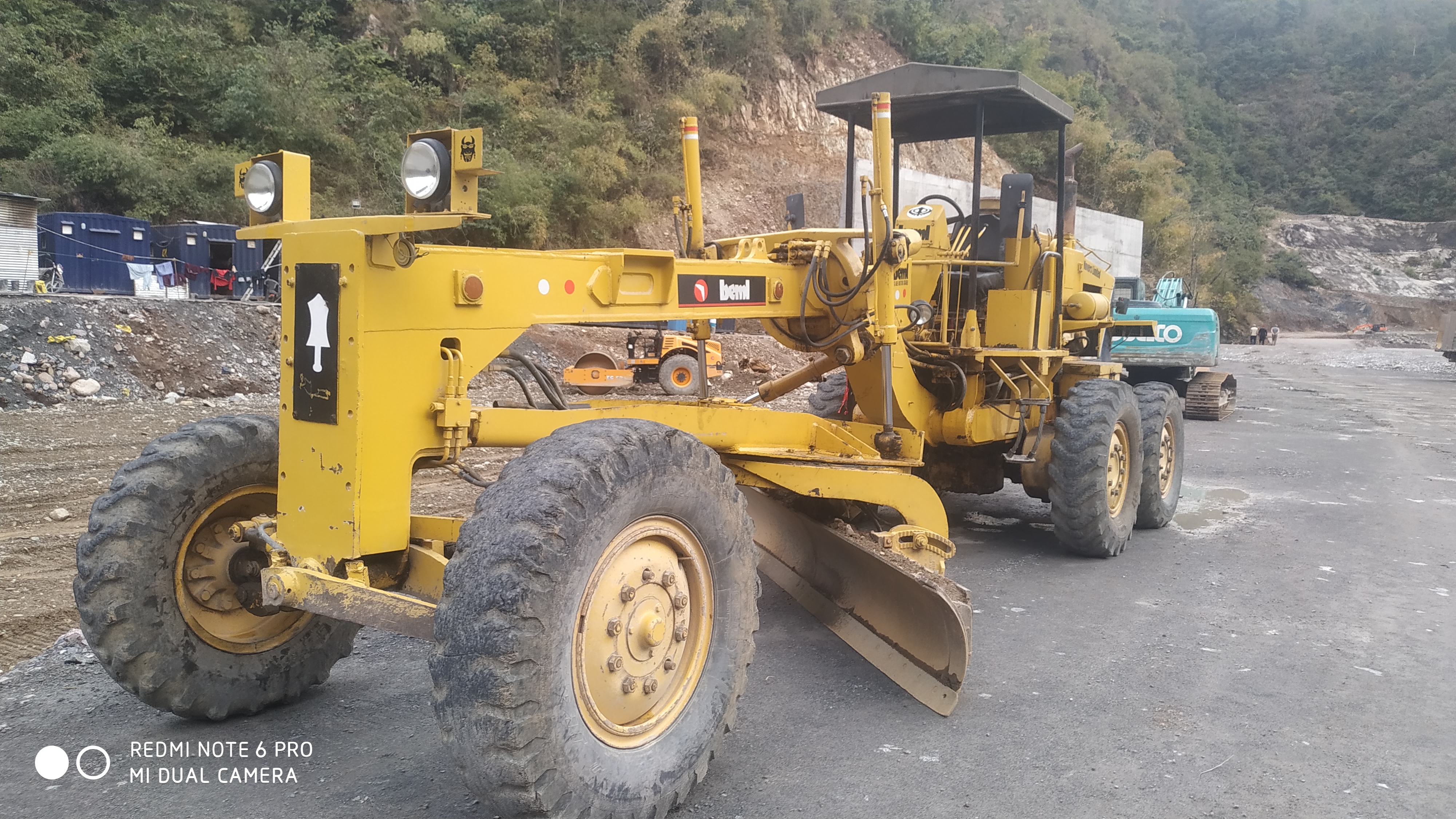Motor grader levelling ground on a road construction site