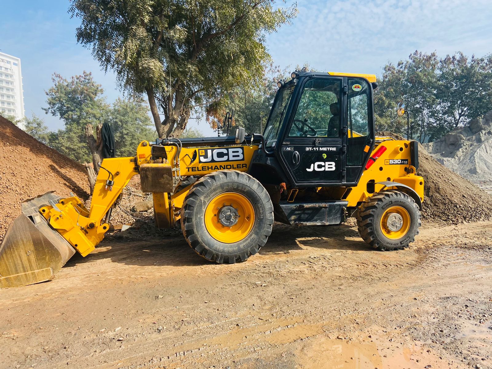 JCB 530-110 telehandler working at construction site